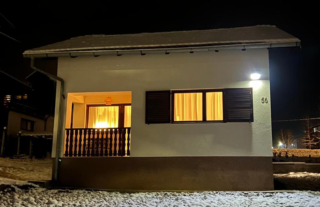 a small house with two windows at night at Kuća za odmor Sedra in Hrvatska Kostajnica