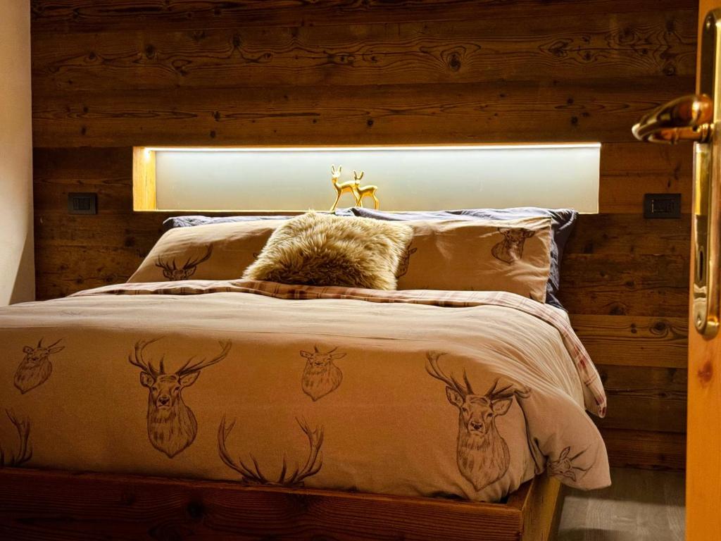 Un dormitorio con una cama con cabezas de ciervo. en Bait da Diego en Livigno