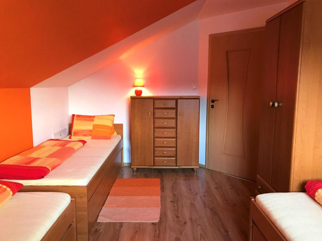 um pequeno quarto com 2 camas e uma cómoda em Penzión Jany em Zuberec