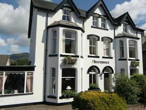 a white house with a sign on the front of it at Silverdale Guesthouse in Keswick