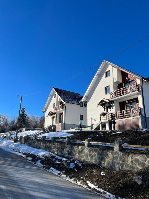 a large white building on the side of a road at Sunčani vrhovi in Raška