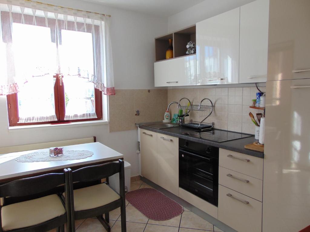 a small kitchen with a sink and a stove at Apartment Dendy in Pula