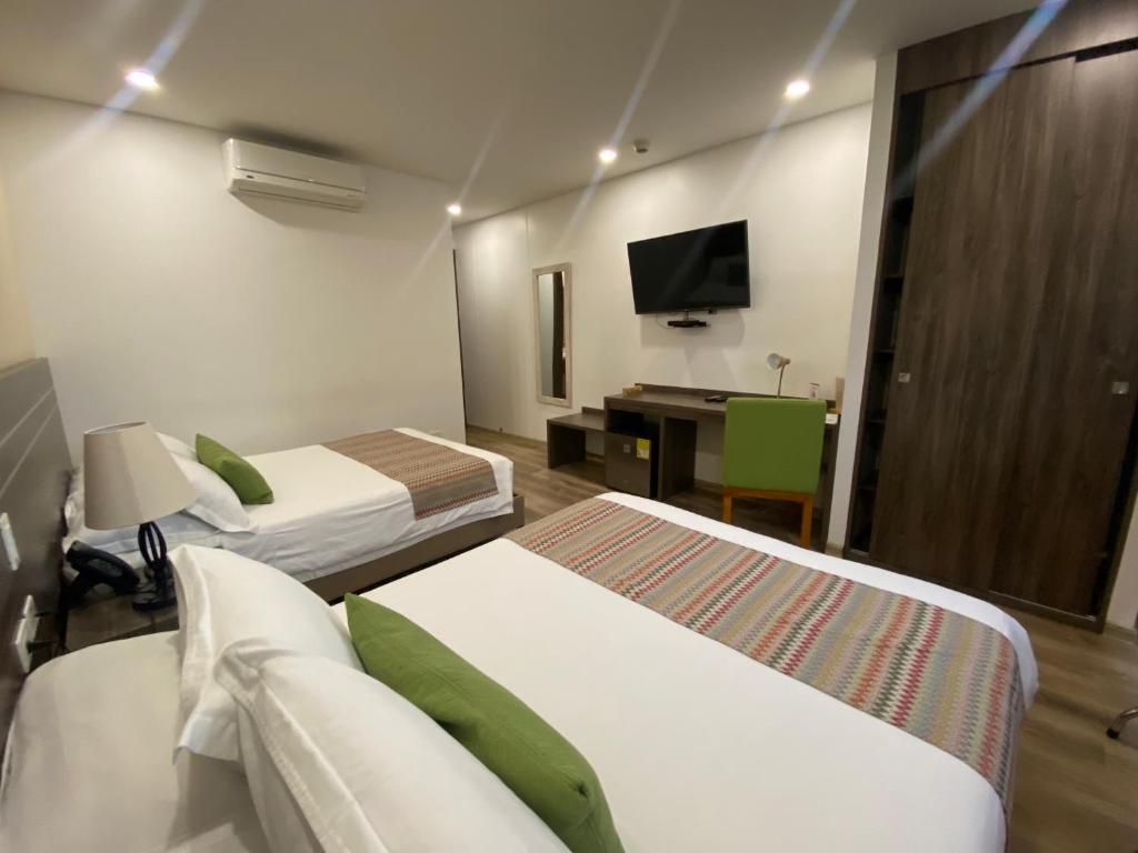 Postel nebo postele na pokoji v ubytování EcoHub Hotel Medellin