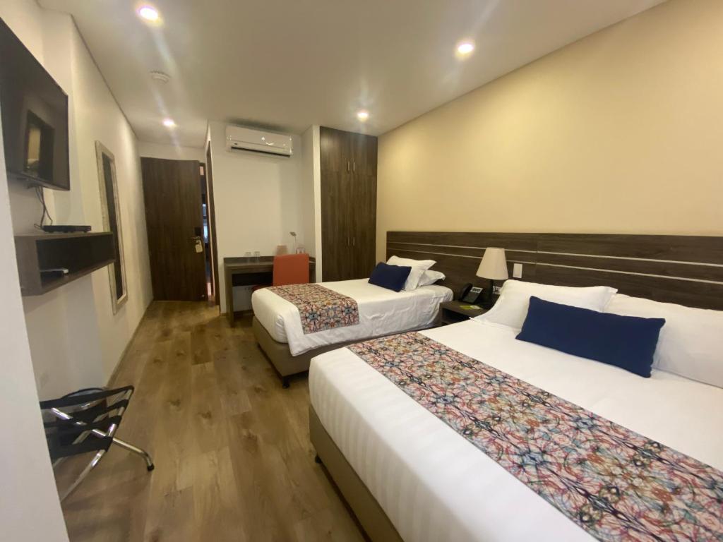 Postel nebo postele na pokoji v ubytování EcoHub Hotel Medellin
