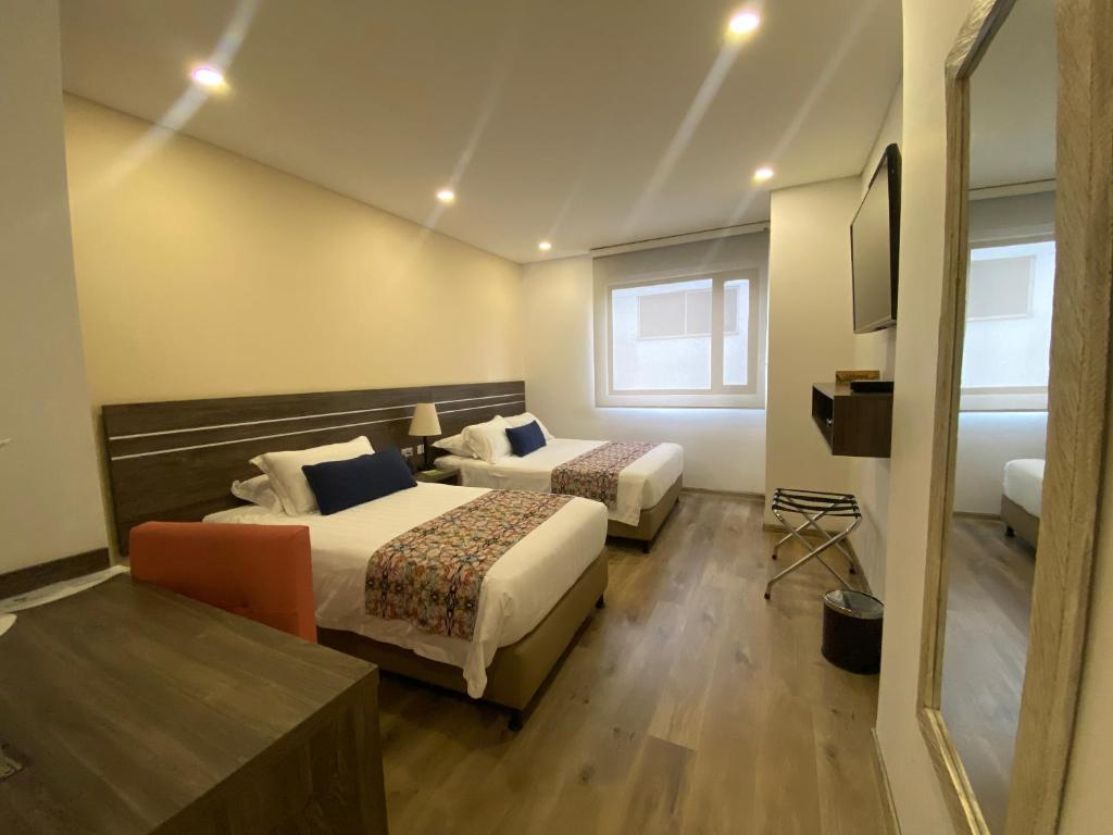 Postel nebo postele na pokoji v ubytování EcoHub Hotel Medellin