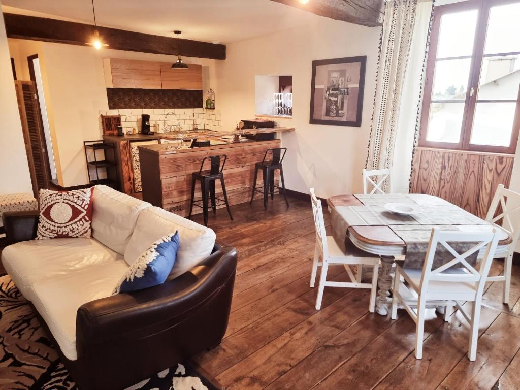 ein Wohnzimmer mit einem Sofa und einem Tisch in der Unterkunft Prestigieuse Résidence : N°6 in Bellac