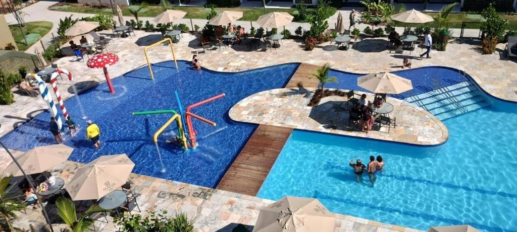 Flat com vista para piscina principal في إيبوجوكا: اطلالة علوية على مسبح فيه ناس