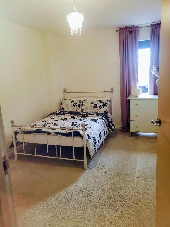a bedroom with a bed and a dresser and a window at Central spacious and secure with a double bed in Colindale
