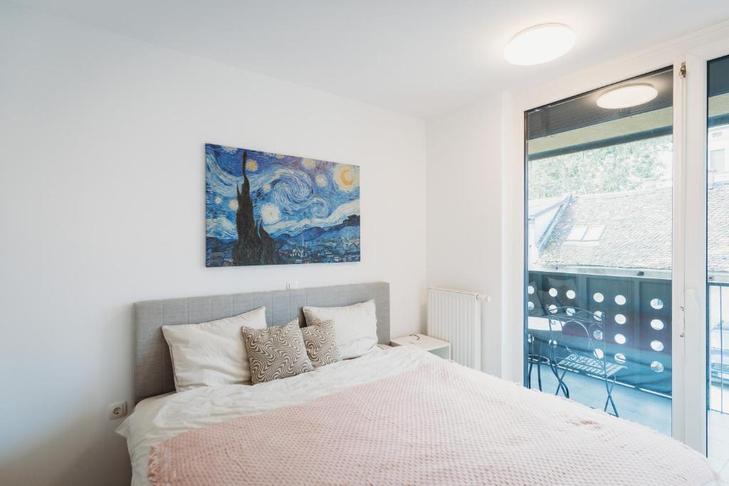a bedroom with a bed and a large window at Peaceful Little Retreat, spacious free garage park in Ljubljana