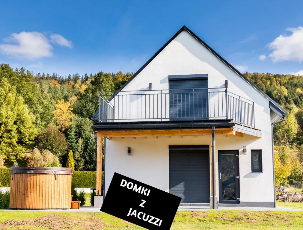 a sign in front of a house with a do not enter sign at Domki u Duszy in Brenna