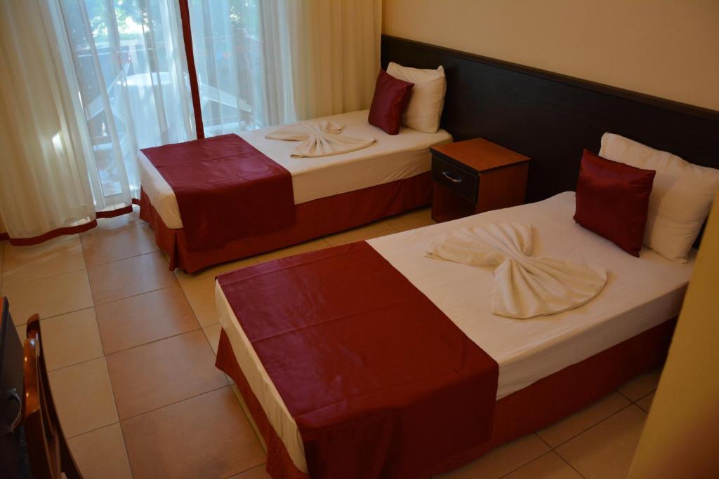 Postel nebo postele na pokoji v ubytování Yavuzhan Hotel