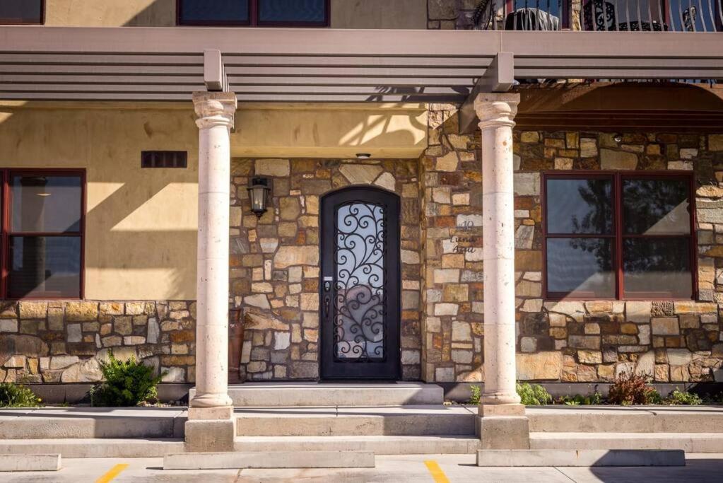 a stone building with a door and two columns at Luxury Downtown Rental (Hot Tub/Pet Friendly) - La Dolce Vita Villas #10 in Moab