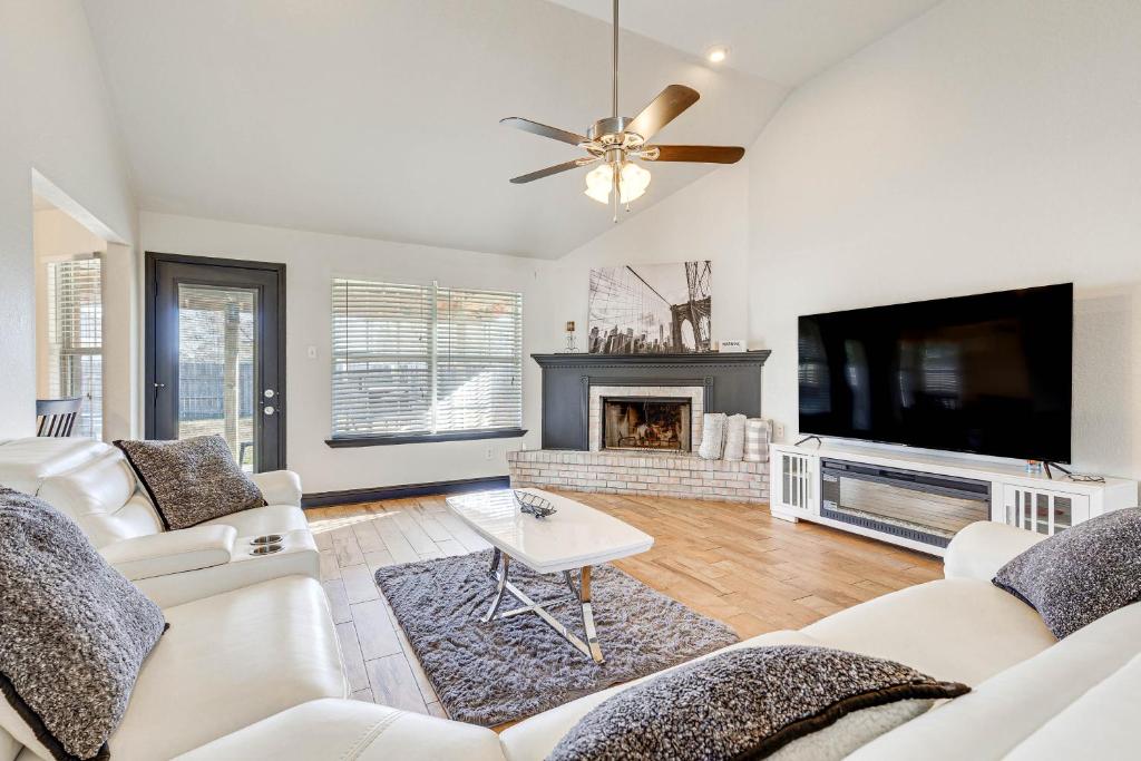 a living room with white furniture and a flat screen tv at Family-Friendly Ocean Springs Home Grill, Hot Tub in Ocean Springs