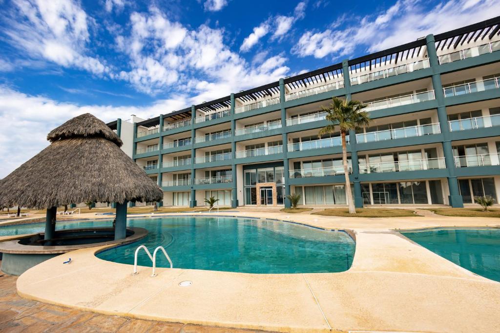 um hotel com piscina em frente a um edifício em Linda Vista 401 em Puerto Peñasco