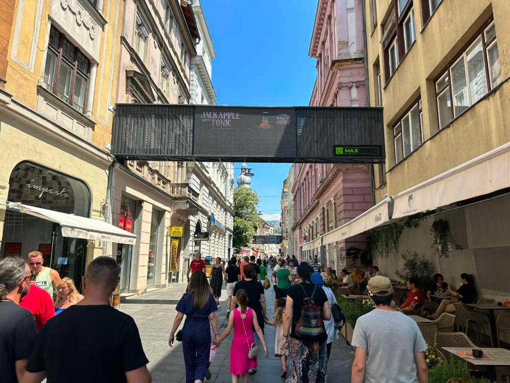 a crowd of people walking down a city street at The heart of Sarajevo Apartment in Sarajevo