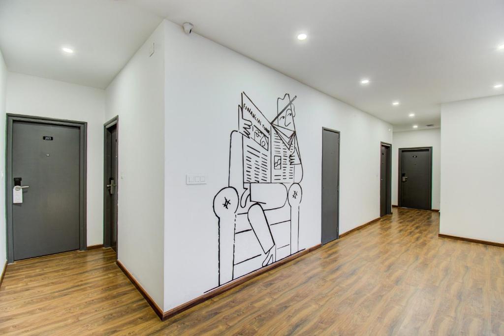 a drawing on a wall in an empty room at Townhouse Prakash continental Near Netaji Subhash Place Metro Station in New Delhi