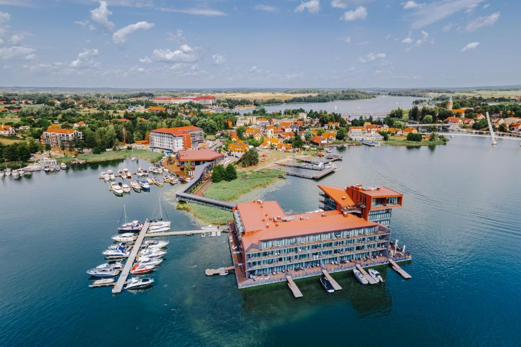 an aerial view of a marina with boats in the water at Hotel Mikołajki Leisure &amp; SPA in Mikołajki