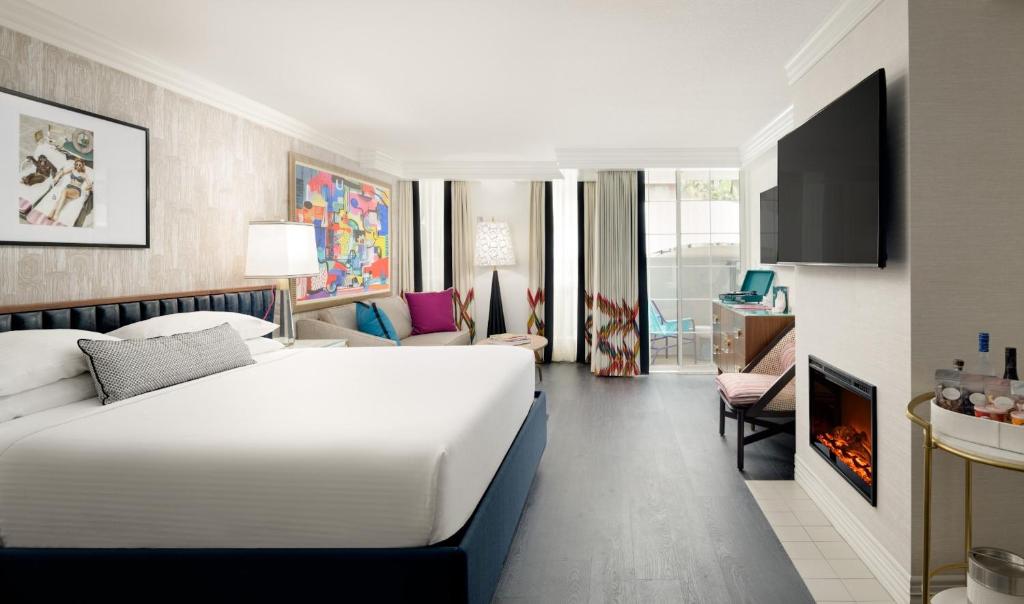 a hotel room with a bed and a living room at Le Parc at Melrose in Los Angeles