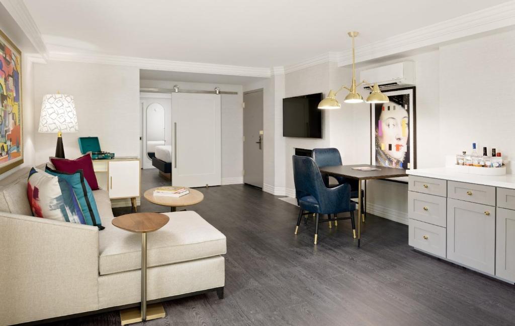 a living room and kitchen with a couch and a table at Le Parc at Melrose in Los Angeles