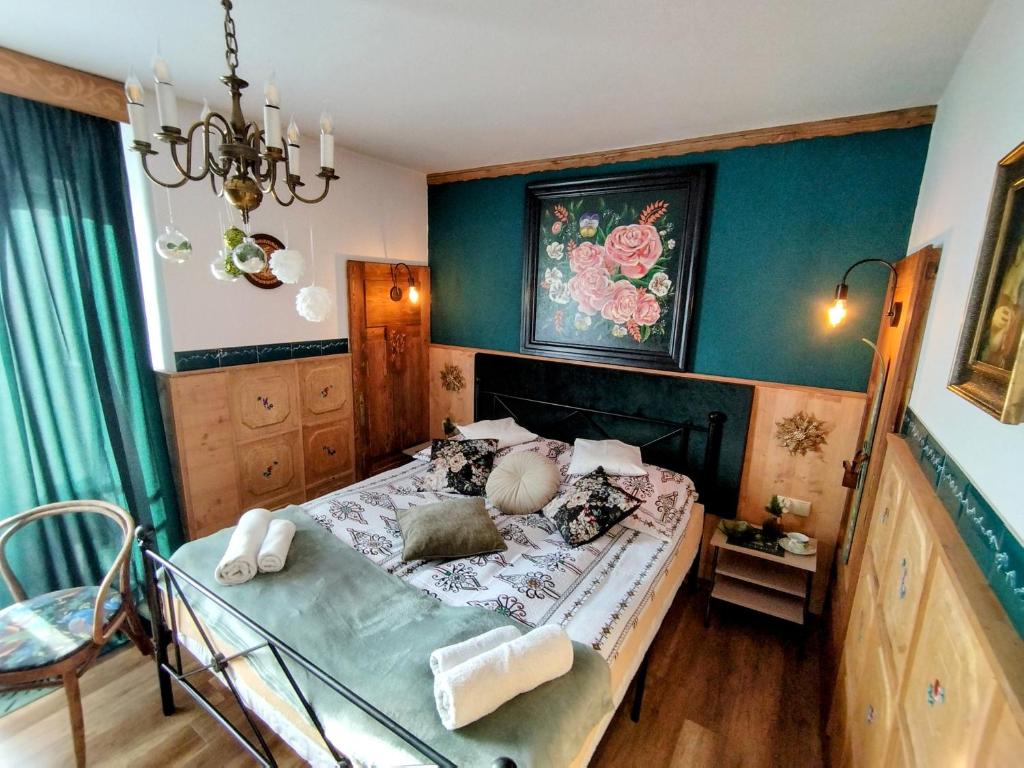 a bedroom with a bed and a chandelier at Willa Polka in Bukowina Tatrzańska