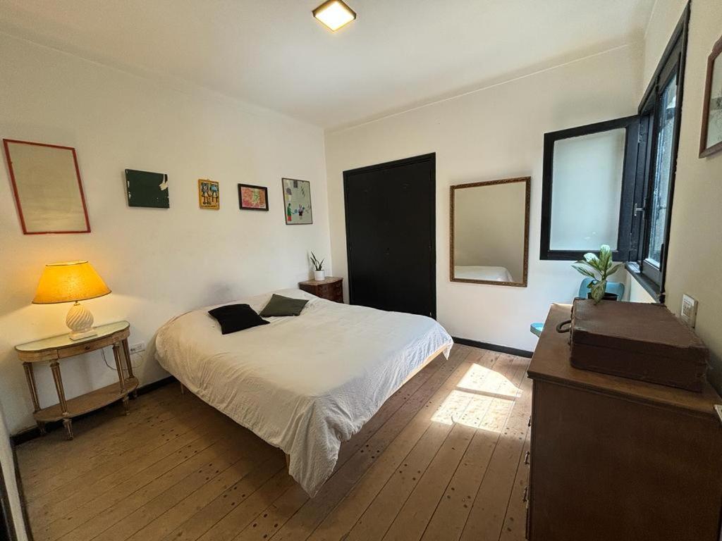 a bedroom with a bed and a table and a lamp at Departamento temporal para 4 personas in Mar del Plata
