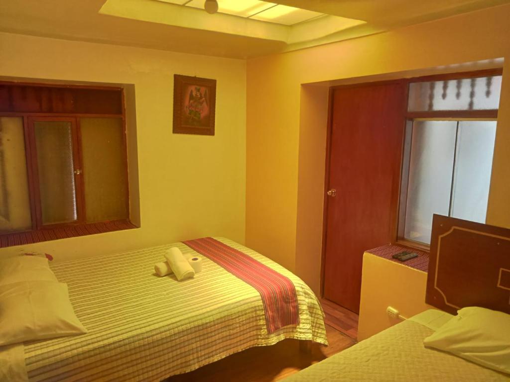 Een bed of bedden in een kamer bij Hospedaje Apu Salka
