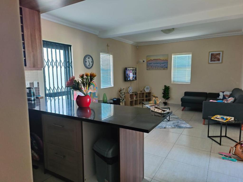 a kitchen and living room with a large counter top at Frank's Place in Yzerfontein
