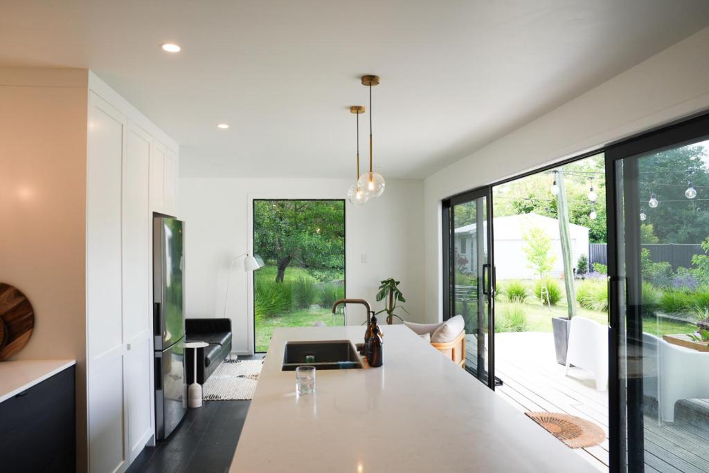 a kitchen with a large white counter and large windows at The Gallery in Havelock North in Havelock North