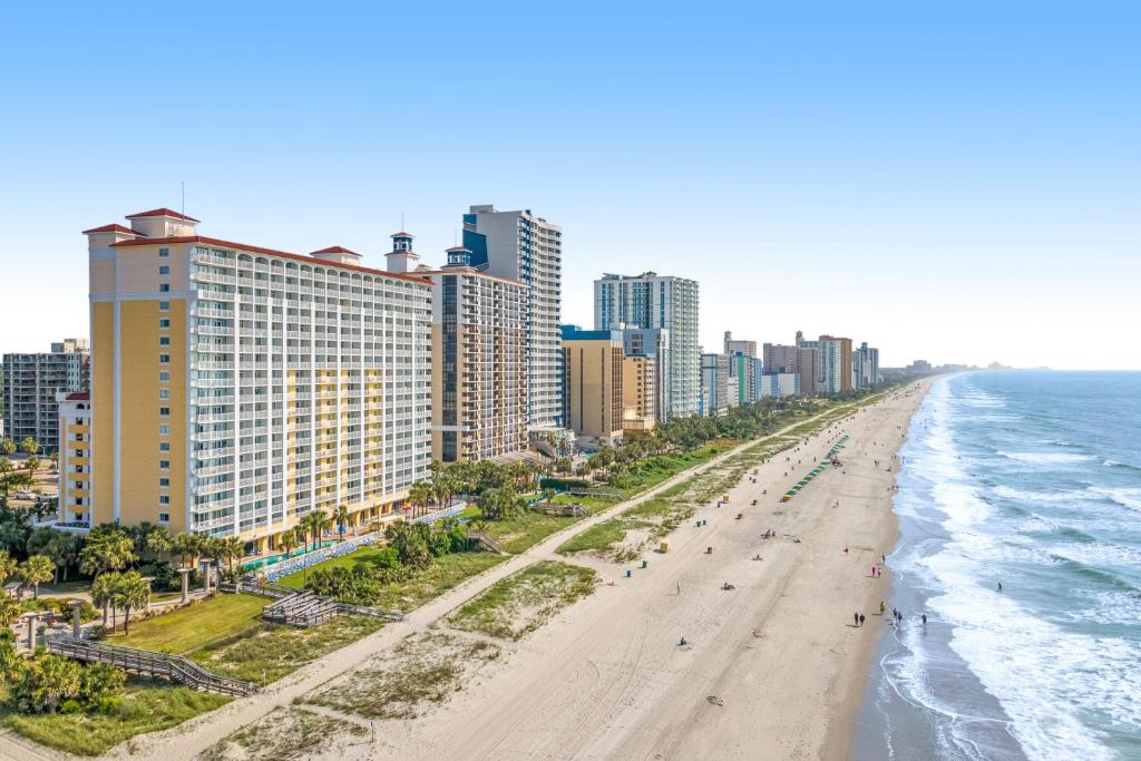 an aerial view of a beach in front of a city at Camelot by the Sea - Oceana Resorts Vacation Rentals in Myrtle Beach