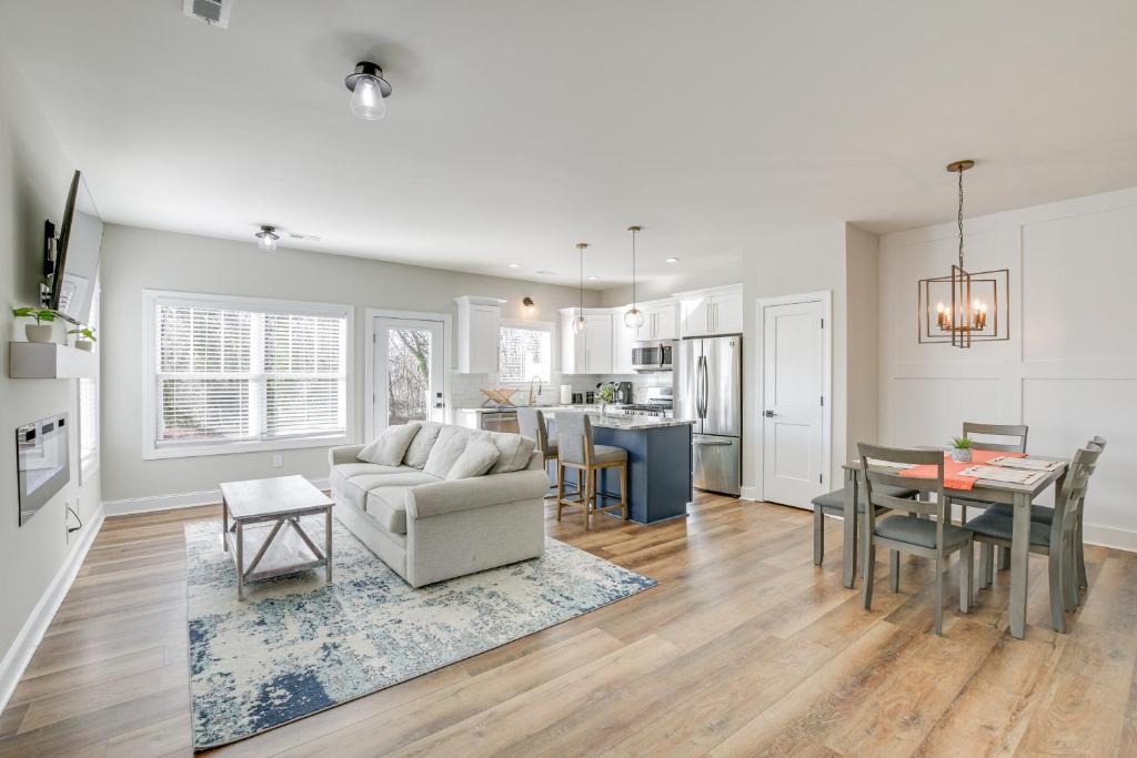 a living room with a couch and a table at Modern Greer Retreat Walk to Historic Downtown! in Greer