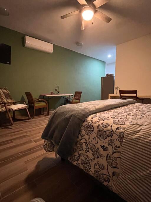 a bedroom with a bed and a ceiling fan at Loft entero en la maya in Mérida