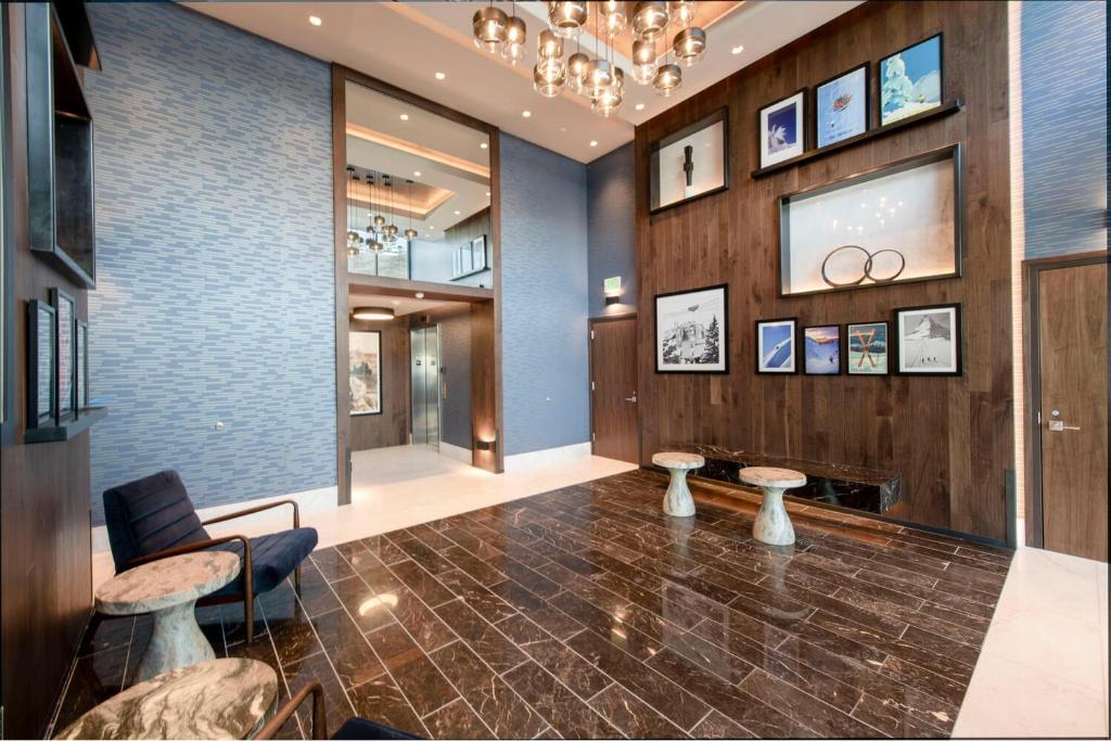 a lobby with two tables and a chandelier at Pioche Village in Park City