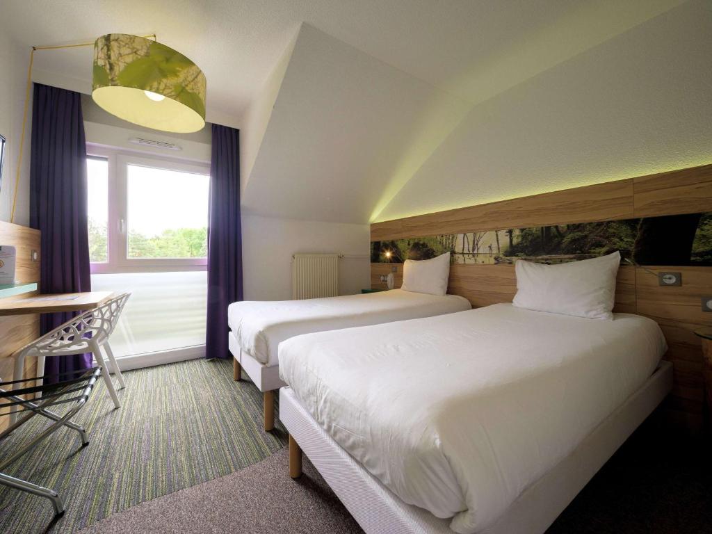 Postel nebo postele na pokoji v ubytování ibis Styles Sarrebourg