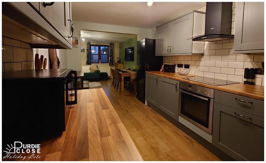 a kitchen with wooden floors and a counter top at Purdie Close Holiday Let in Cheddar