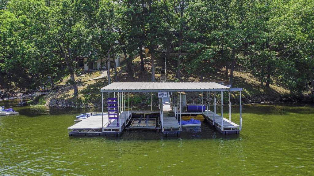 a dock in the middle of a body of water at 6bedrooms, ramp boat dock slips water toys, nice cove area in Linn Creek
