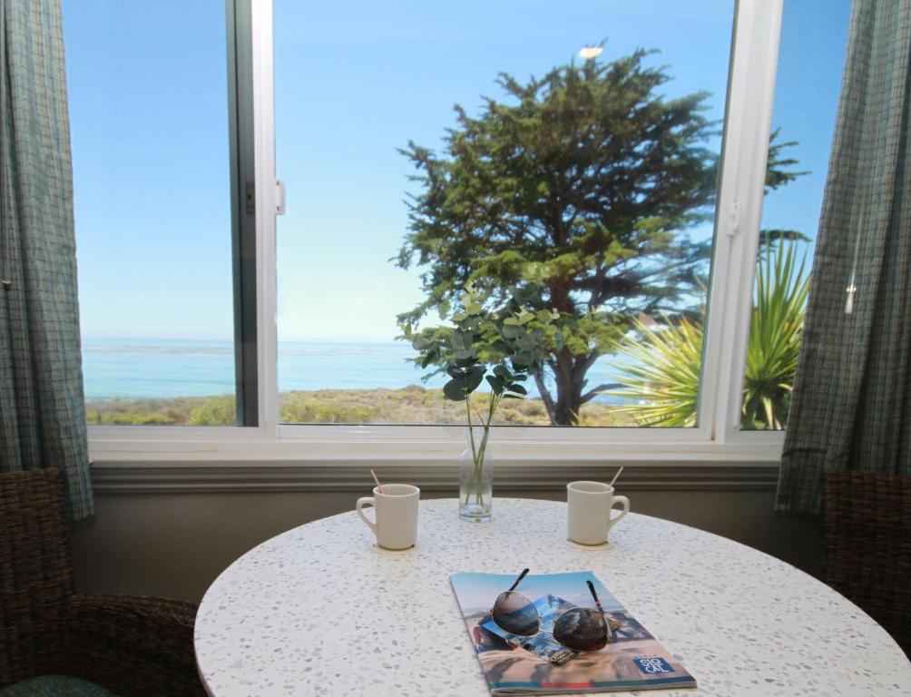 a table with a plate of food on it with a window at Castle Inn in Cambria