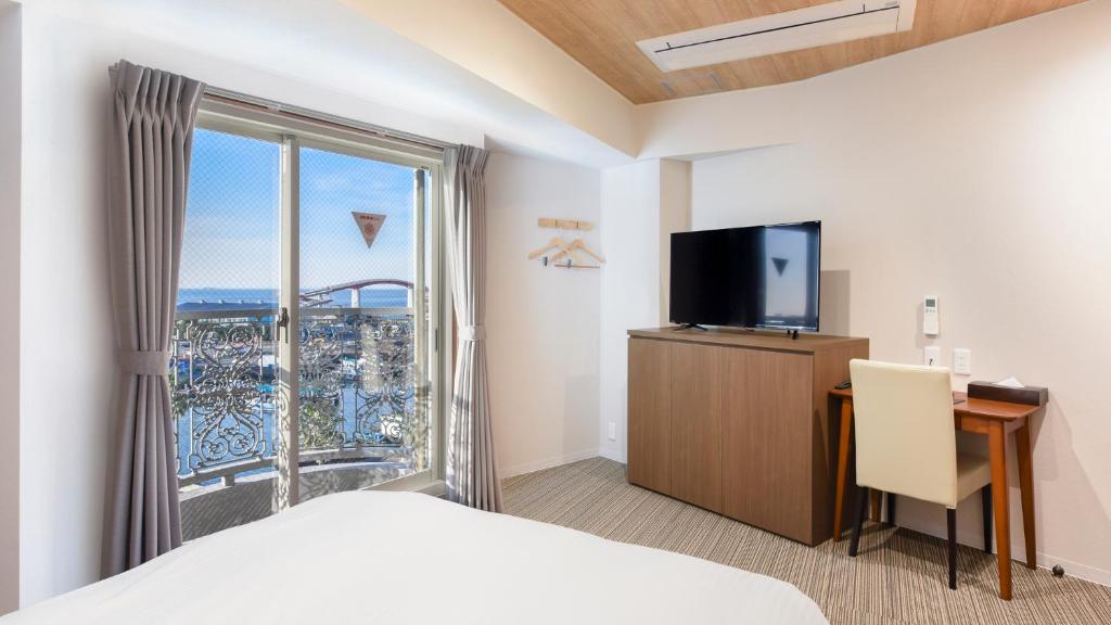 Postel nebo postele na pokoji v ubytování kisarazu bay Town Hotel