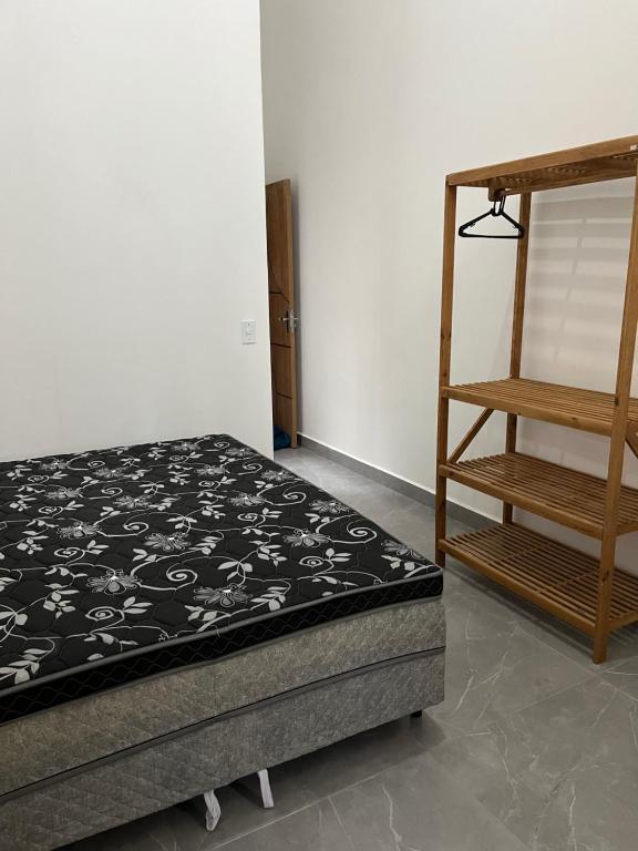 a bedroom with a bed and a wooden ladder at Casa Esmeralda in Guaratuba