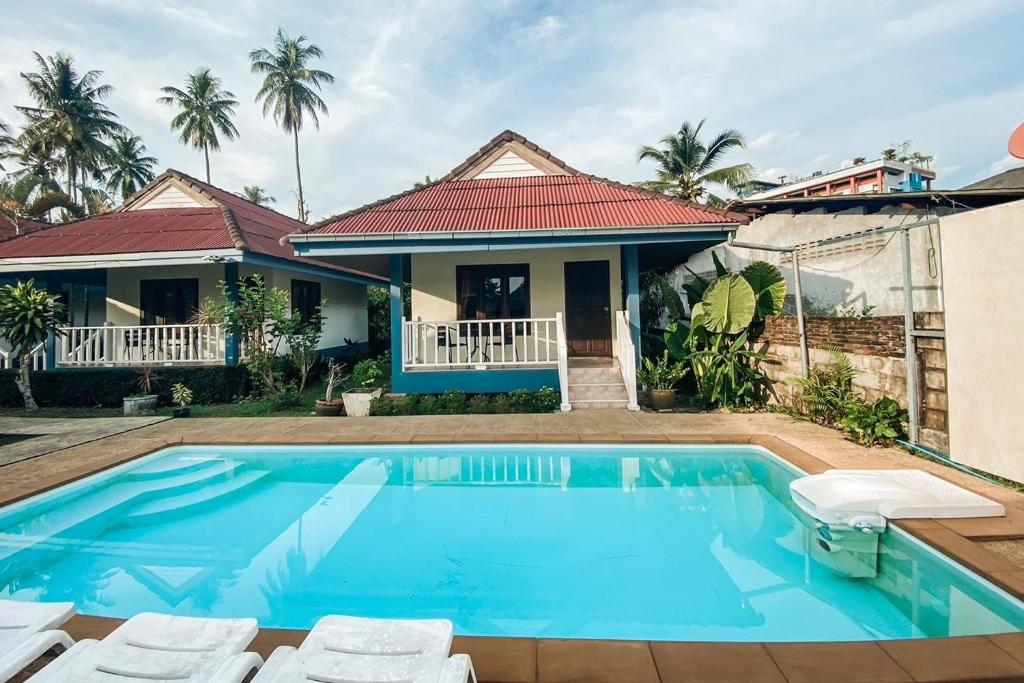 a villa with a swimming pool and a house at House No.2 Village in Krabi town