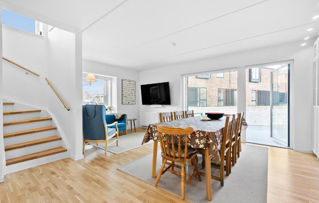 a kitchen and dining room with a table and chairs at Amazing Home In Niv With Kitchen in Nivå