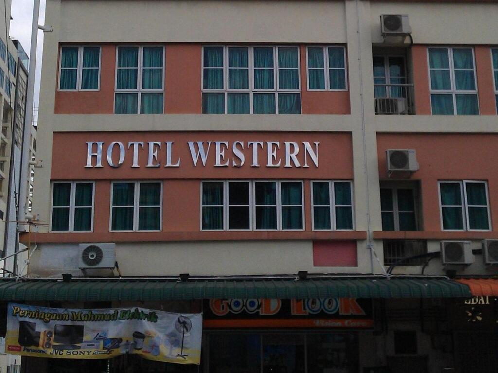 a hotel sign on the side of a building at Hotel Western in Sandakan