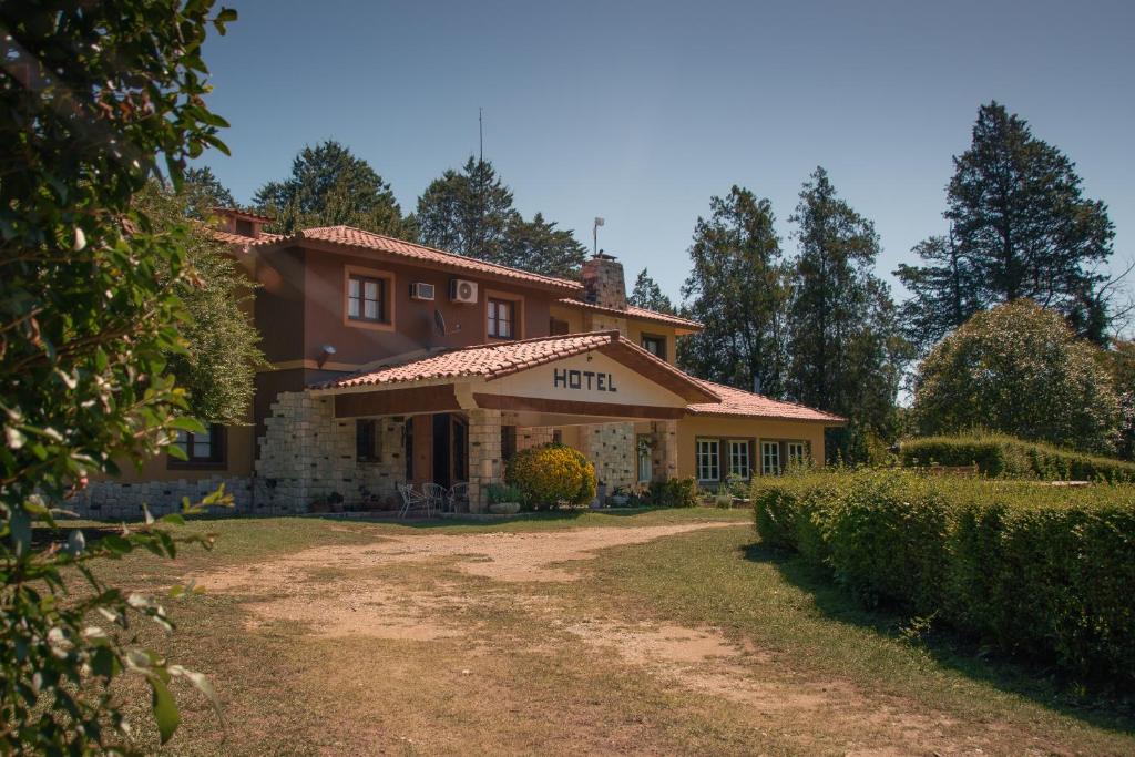 uma casa com uma estrada de terra em frente em Hotel Lago Los Molinos em Villa Ciudad de America