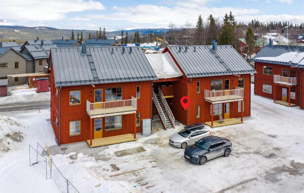 una casa roja con un coche aparcado delante de ella en Beautiful Apartment In Funsdalen With Wi-fi, en Funäsdalen