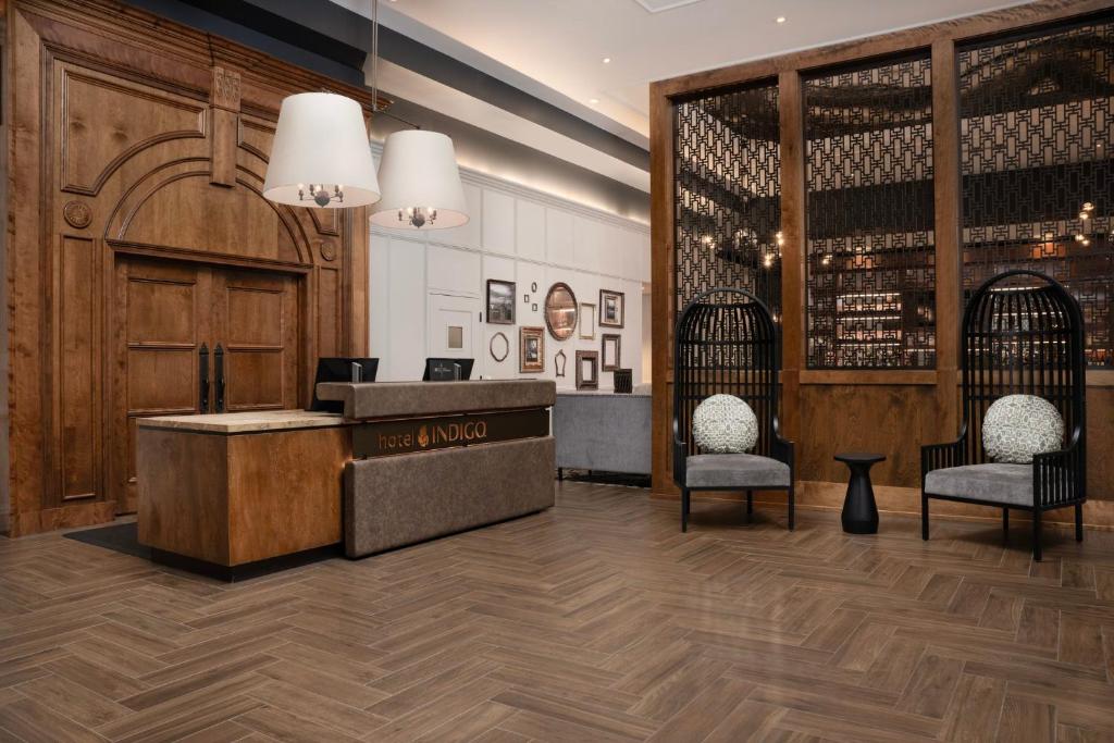 a lobby with a reception desk and two bird cages at Hotel Indigo Baltimore Downtown, an IHG Hotel in Baltimore