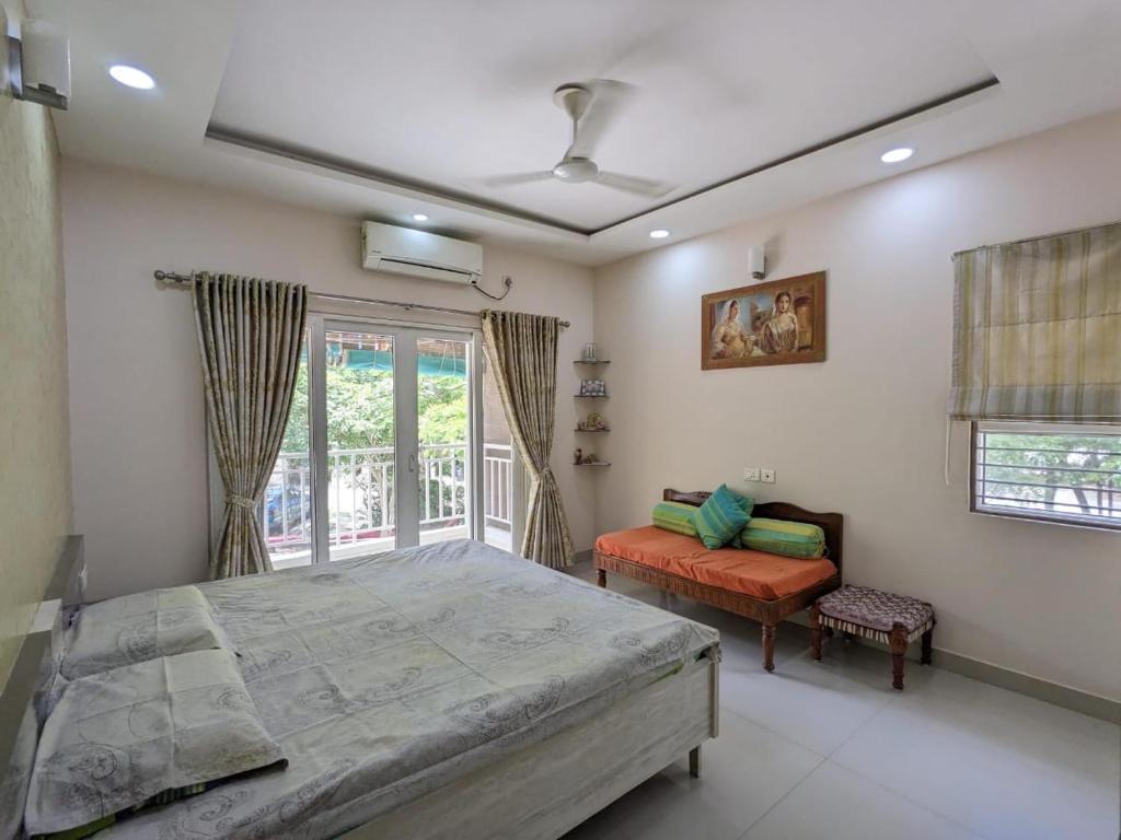 a bedroom with a large bed and a window at Soul House_4.5 BHK Apartment in Ahmedabad