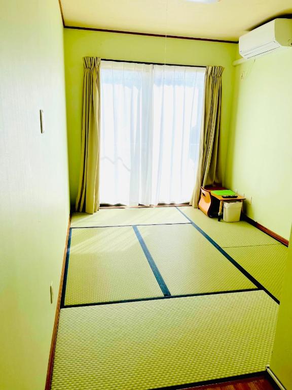 an empty room with a large window and a floor at Joya in Ishigaki Island