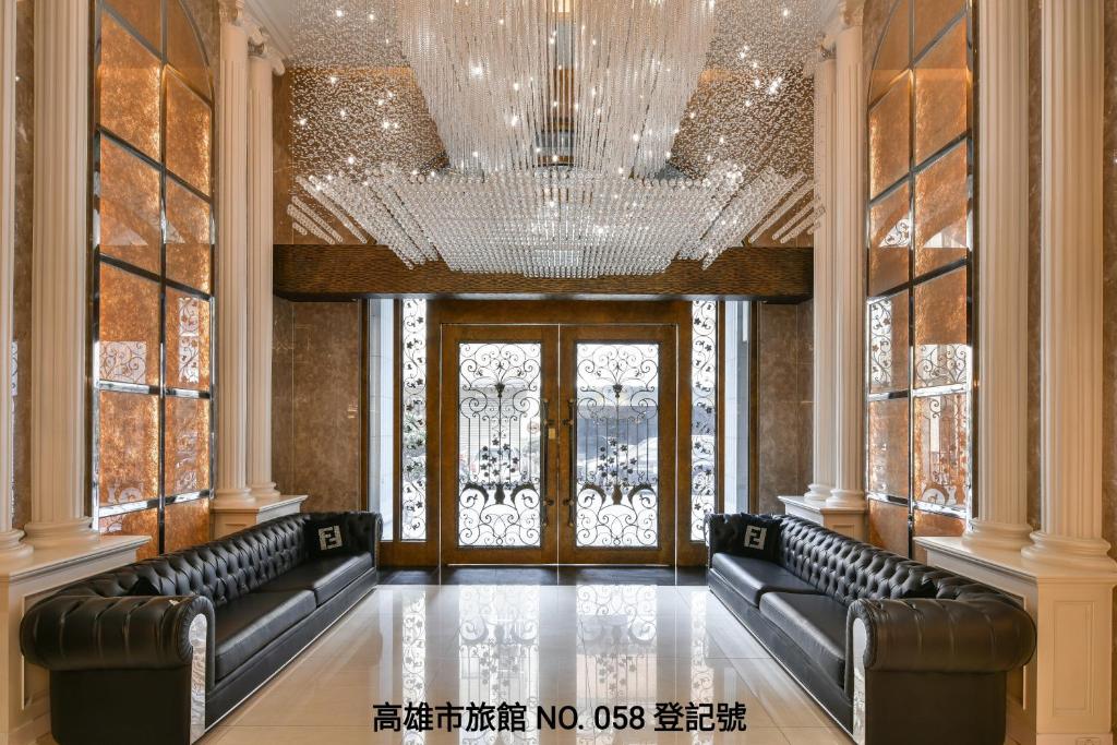 Cette grande chambre est dotée de fauteuils en cuir et d'un lustre. dans l'établissement Harmonious Hotel, à Kaohsiung