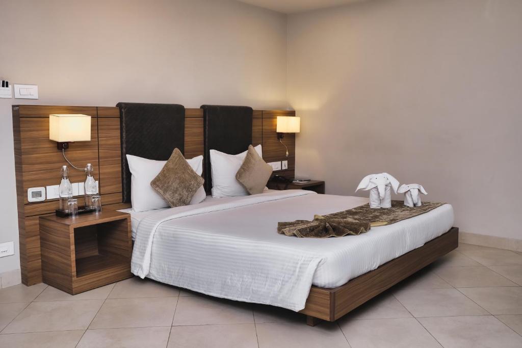 Postel nebo postele na pokoji v ubytování Peerless Hotel Durgapur