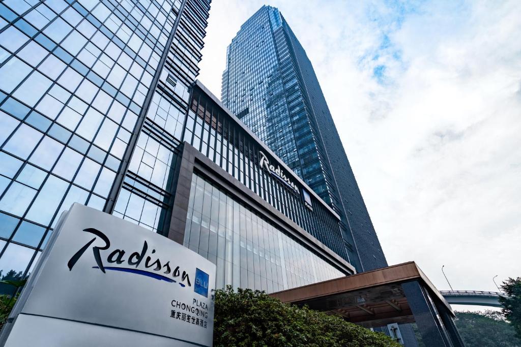 a tall building with a sign in front of it at Radisson Blu Plaza Chongqing in Chongqing