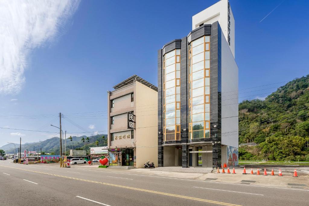 a tall building on the side of a road at Quan Ming B&B in Dahu